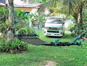 A white van parked in a lush garden with a hammock and ropes. - Dominic's Home by Interhome (Weligama)