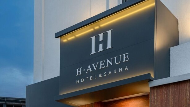 A modern hotel sign with 'H A V E N U E' and 'HOTEL & SAUNA' indicating the establishment's name and services. - H Avenue Hotel Andong Culture Street (Andong)