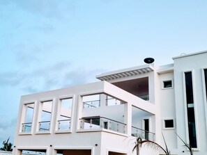 A modern two-story building with a balcony and large windows. - Villa Bolati, mit Pool, Jacuzzi, Aussicht und Garten by Interhome (Yaou)