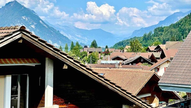 A mountainous village with traditional houses and a clear sky.
