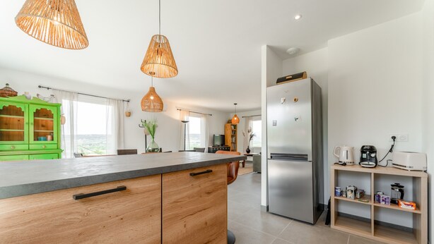 A modern kitchen with a large island, stainless steel refrigerator, and wooden cabinetry. - Villa 'Lo Ginest' with Mountain View, Wi-Fi, and Air Conditioning (Villedieu)