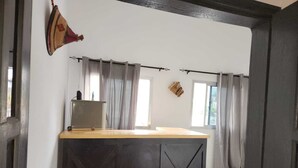 A kitchen with a wooden countertop, dark cabinets, and a hanging light fixture. - Private rooms in a Villa - Abidjan, Ivory Coast (Abidjan)