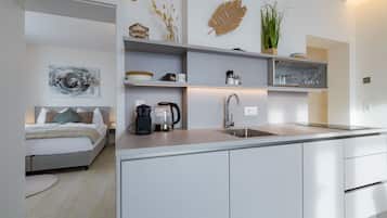 A modern kitchen with a built-in island, a coffee machine, and a sink.
