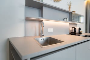 A modern kitchen with a stainless steel sink, a built-in oven, and a coffee machine. - Mohr am Semmering (Semmering)