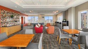 A hotel lobby with a pool table, seating area, and a bar with a mosaic wall. - Apartment Steps from Pentagon City Metro (Arlington)
