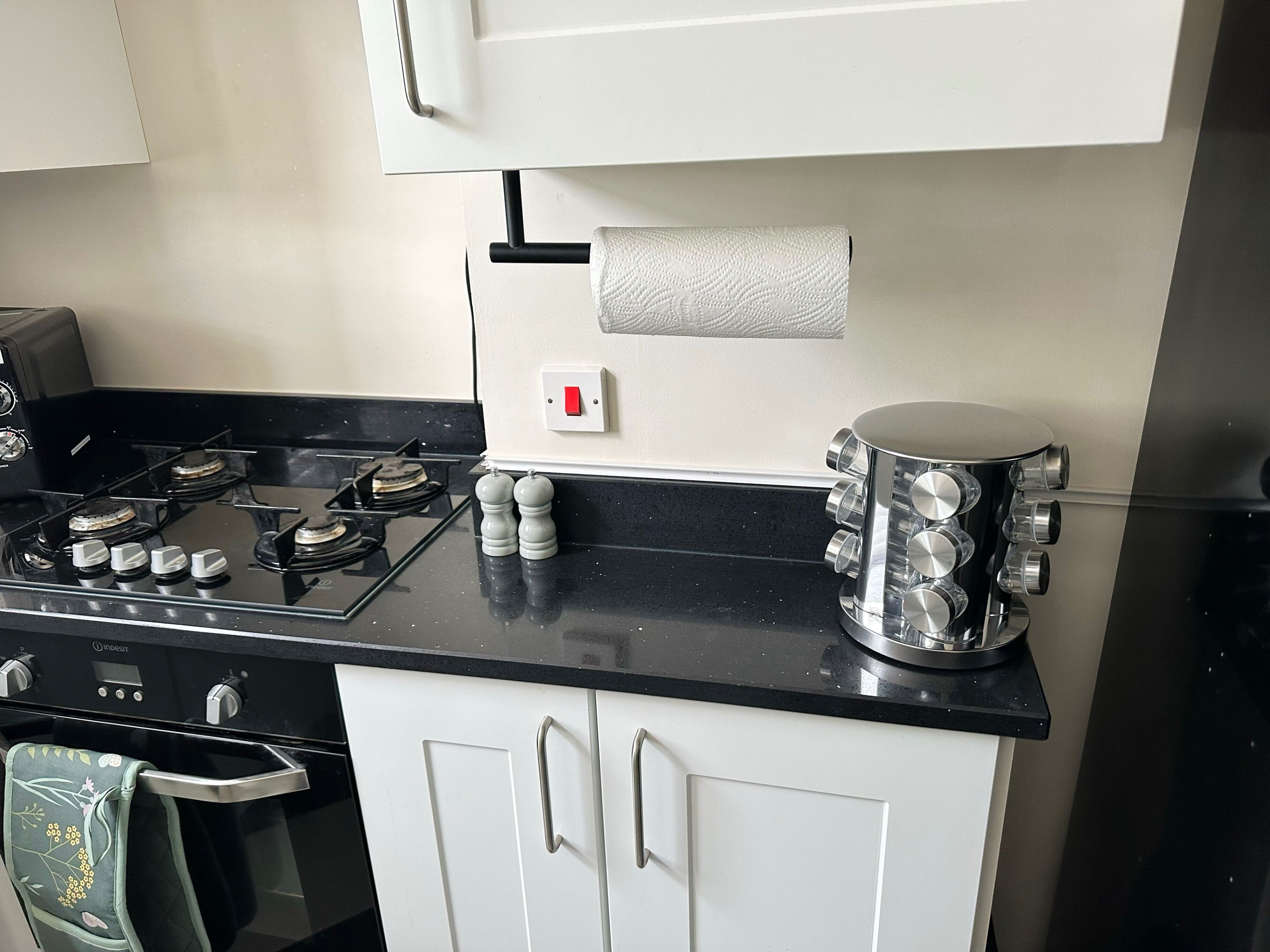 A kitchen with a stove, oven, and cabinets.