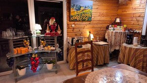 A cozy room with a wooden interior, a painting on the wall, and a table with various items.