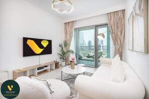 Luxury Apartment, Balcony, City View | Living area | 55-inch Smart TV with cable channels - Vogue | Downtown with Direct Access to Dubai Mall (Dubai)