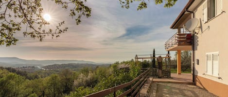 Una casa con balcón que domina un paisaje pintoresco.