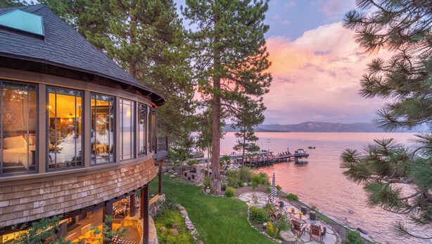 A lakeside property with a wooden deck, outdoor seating, and a view of the lake. - Tewesi Manor | Historic Tahoe Lakefront w/ Private Pier (Carnelian Bay)