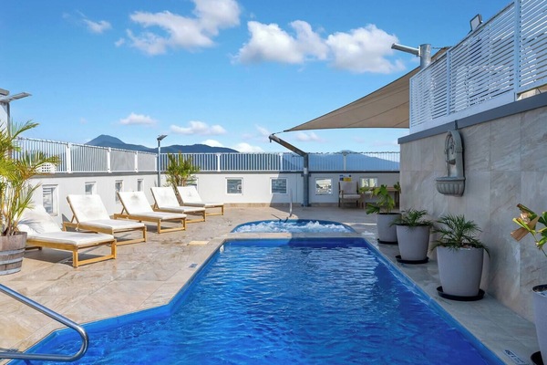 The rooftop pool is the perfect place to cool off while enjoying elevated city and mountain views.