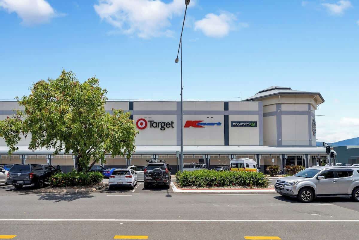 A Target store with a parking lot, a tree, and a clear blue sky.