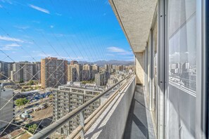 A high-rise balcony with a view of a cityscape, featuring multiple buildings and a clear sky. - Central Apartment with Wifi & views in Santiago (Santiago)