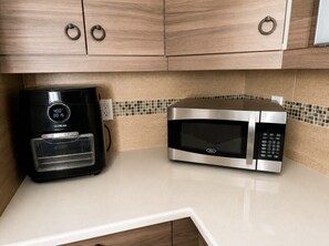 A kitchen with a coffee maker and a microwave on a countertop. - Entire Home Heated Pool Just Minutes from Hollywood Beach and Hard Rock Stadium (Hollywood)