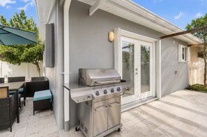 An outdoor patio with a stainless steel grill, wicker furniture, and a covered seating area. - Private Pool • Sleeps 8 • Near Beach, Downtown Hollywood, Stadium Events & FLL airport (Hollywood)