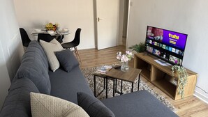A living room with a sofa, coffee table, and TV.