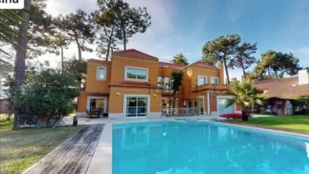 A two-story building with a swimming pool in front. - Luxury Villa Aroeira (Setúbal)