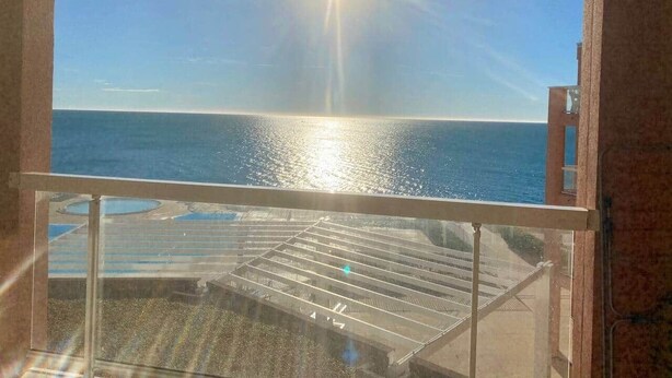 A balcony with a view of the ocean and a pool area. - "578" Superb T2 Sea Front, Parking, Air Conditioning (Sète)
