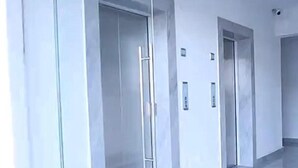 A modern hallway with glass doors and a polished floor. - 1BR Luxury Suites near Airport with pool/gym/Cityview (Nairobi)