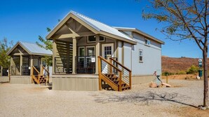 A two-story building with a balcony and wooden staircase. - HTR Moab (Moab)