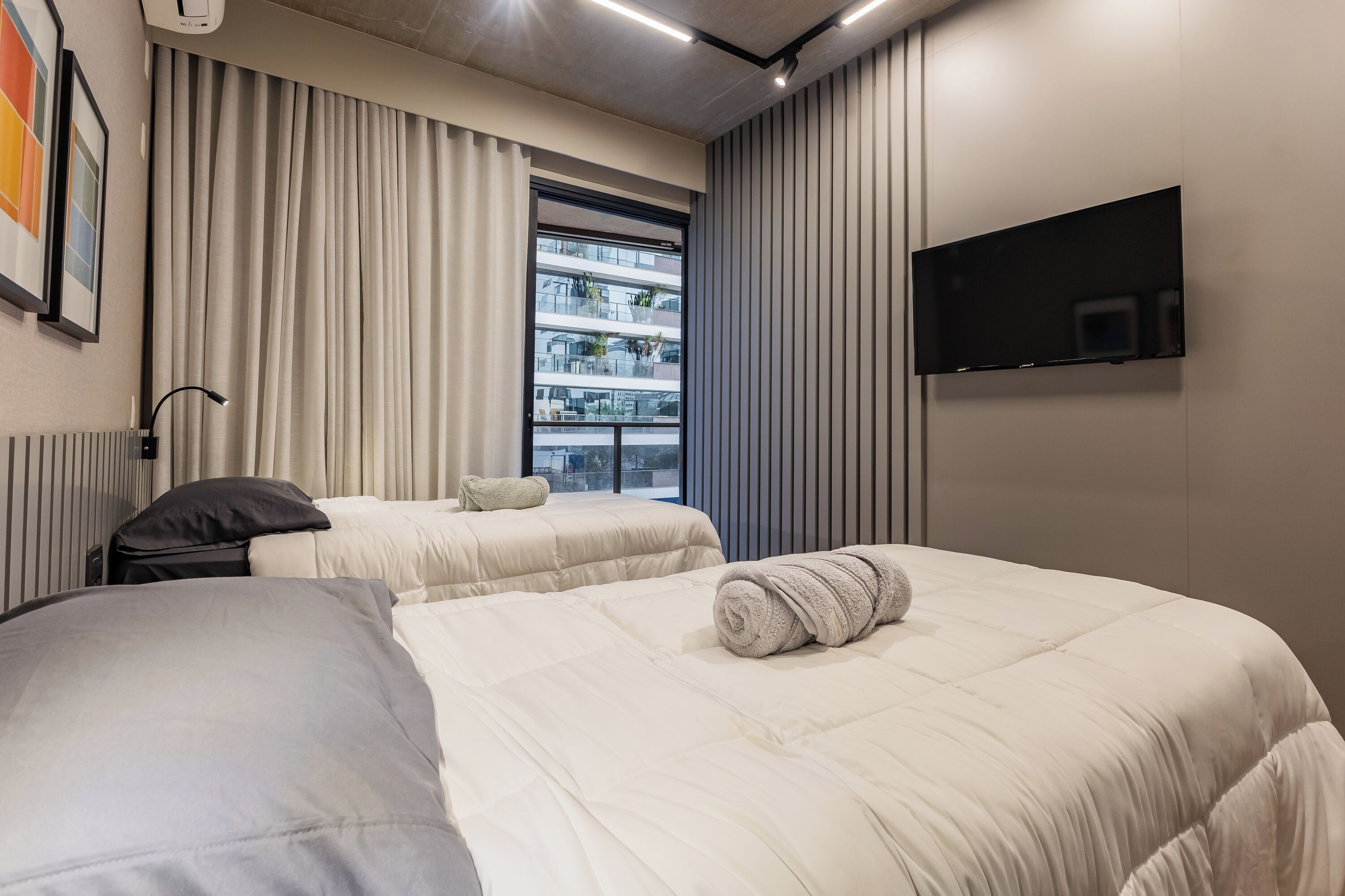 Premium bedding, desk, laptop workspace, blackout drapes