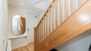 A staircase with wooden railings leading to a landing. A white door is visible in the background. - Duplex Apartment - Modern & Convenient - Pass the Keys (Reading)