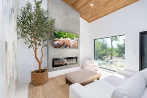 TV, fireplace, offices - Villa Bayou- Modern Waterfront Home on Clam Bayou (Sanibel)