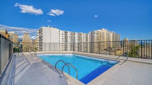 A rooftop swimming pool with a clear view of surrounding high-rise buildings. - Nomad Stay  Pool, Wifi near La Moneda (Santiago)