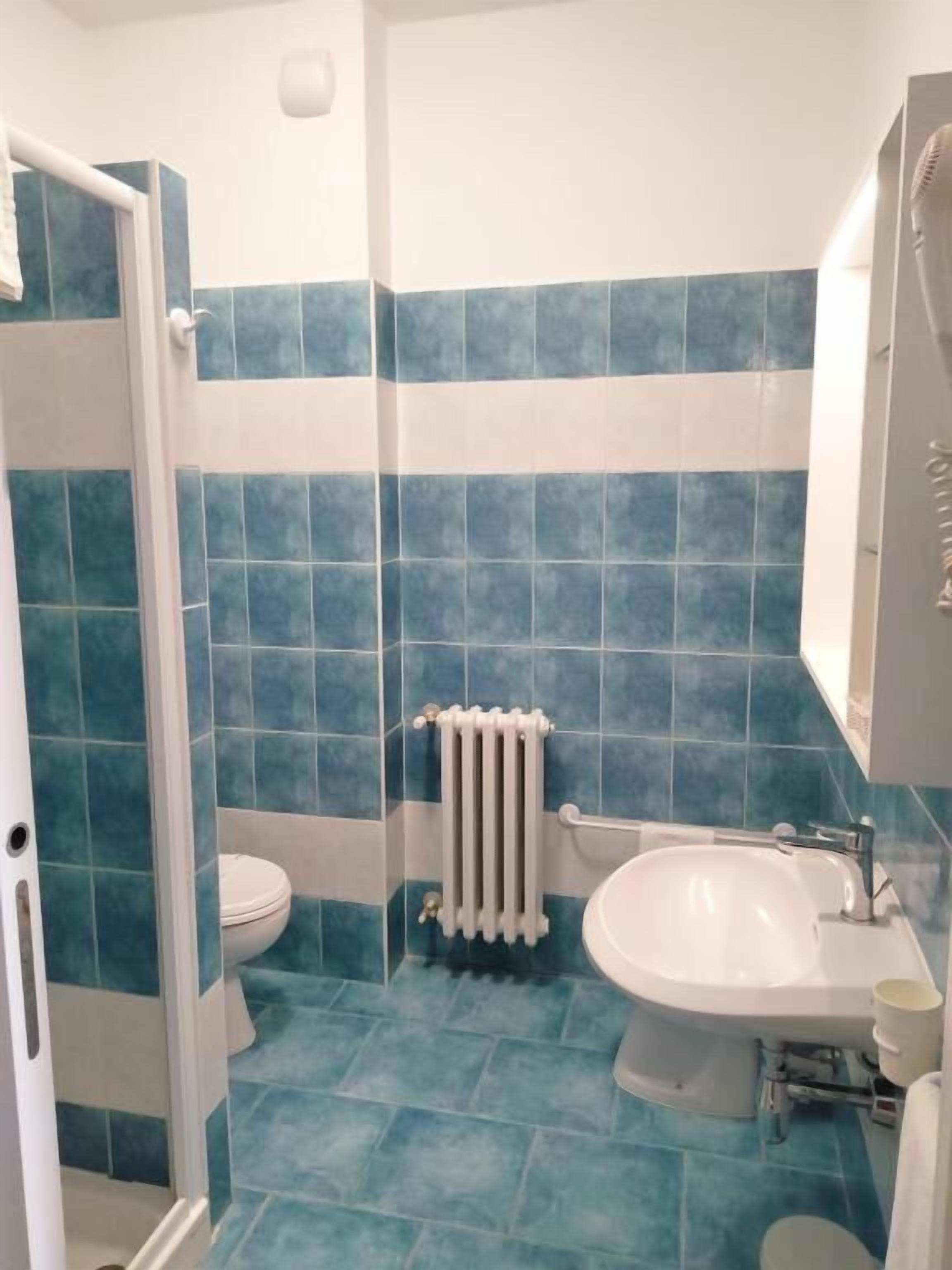 Shower, hair dryer, slippers, towels