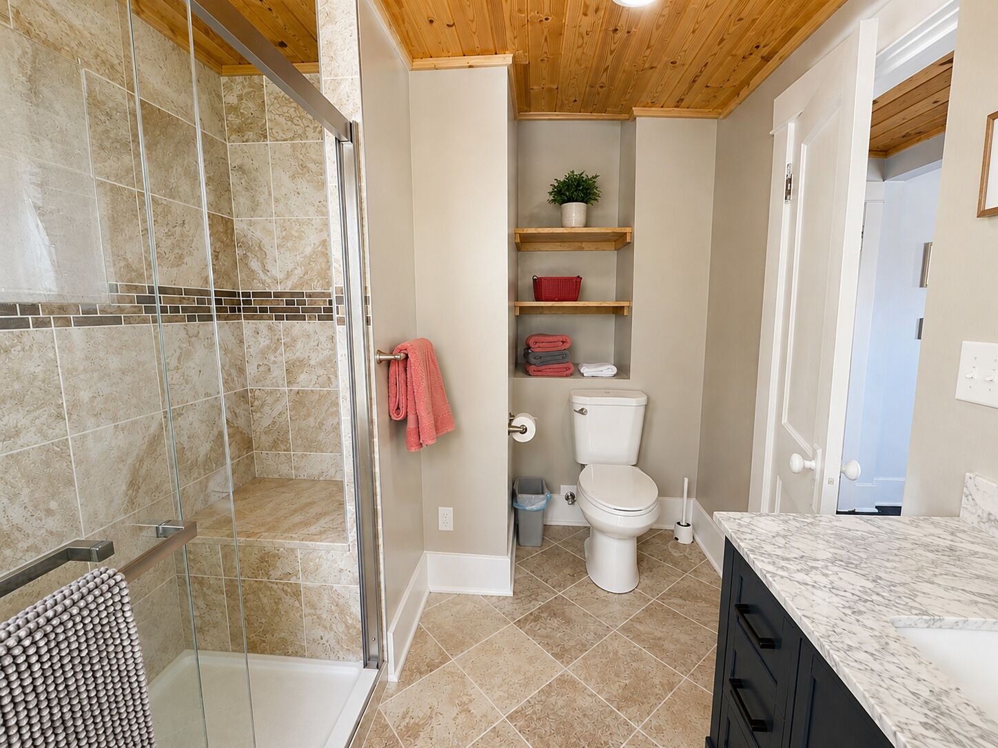 A bathroom with a shower, toilet, and sink.