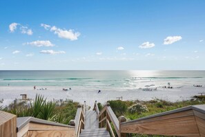 A wooden staircase leading to a beach with a clear sky and calm sea. - Gulf Place Cabanas 110 - Highway 30A- 120 Steps to Beach - Walk to Shunk Gulley! (Santa Rosa Beach)