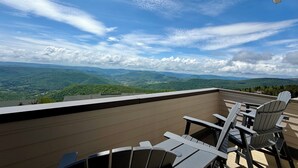 A balcony with Adirondack chairs overlooking a mountainous landscape. - Ski In Ski Out Top Floor 2 BR Seneca Corner Unit. Newly Renovated-Garage Parking (Snowshoe)