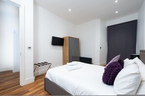 A modern bedroom with a bed, a wardrobe, a television, and a radiator. - Stunning London Home - Newly Furnished Mhb352 (London)