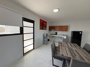 A modern kitchen with a dining area.