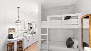 A compact, modern room with a kitchenette, a bunk bed, and a dining area. - The Inn at Seacrest Beach Unit 207 (Alys Beach)
