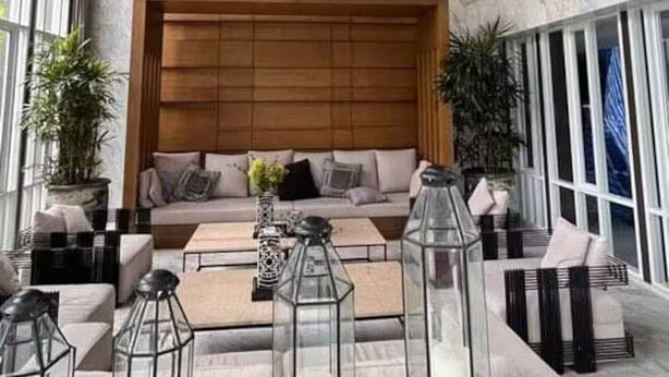 A spacious living area with a wooden ceiling, large windows, and a central seating area with a sofa and coffee table. - The Base Downtown Phuket By Ploy (Wichit)