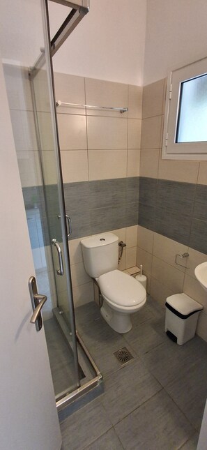 A bathroom with a glass shower enclosure, a toilet, a bidet, and a sink. - Villa kavourakia studio with sea view (4CRX+VJ Skiathos)