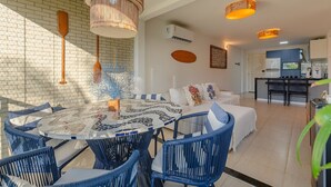 A modern kitchen with a dining area. - Beach Place #202 - Seafront by Carpediem (Aquiraz)