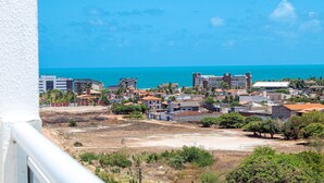 A coastal town with buildings, a clear blue sky, and the sea in the background. - Exclusive Duplex at Beach Townhouse IV by Carpediem (Aquiraz)