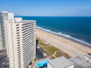 A high-rise hotel overlooking a beach with a parking lot and a swimming pool. - Ocean View Atlantis Studio - Sleeps 4 (Ocean City)