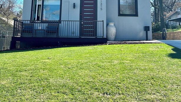 A modern two-story house with a balcony, large windows, and a door with a number '1315' on the side. - Home Base for World Cup (Kansas City)