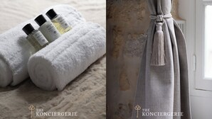Una toalla blanca doblada con esmero y tres botellas de colonia Acqua di Parma.