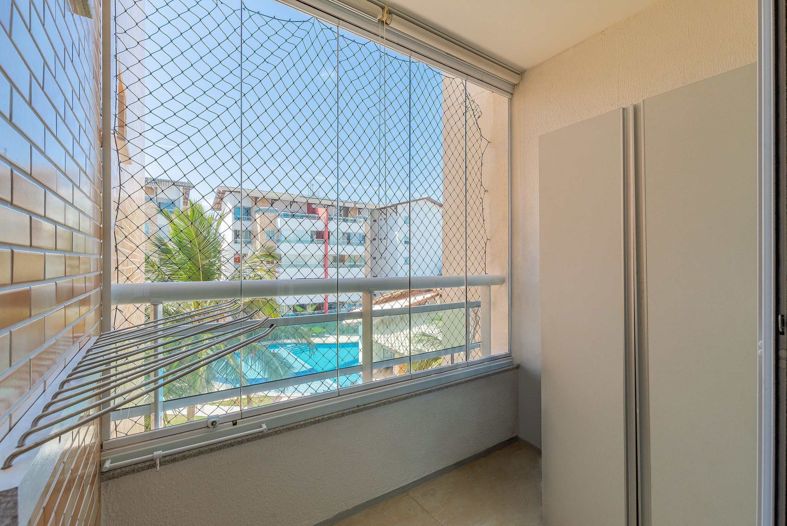 Un balcón con vista a una piscina y edificios.