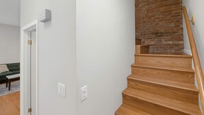 A staircase with wooden steps and a brick wall.
