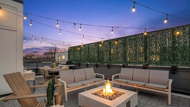An outdoor seating area with a fire pit, string lights, and a green wall. - Sleeps 20: Views, HotTub, FirePit, Grill, Parking (Nashville)