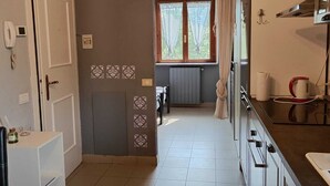 A kitchen with a window, a refrigerator, and a sink. - Farmhouse Tenuta Blueberry - Mirtillo - near airport & Lake Maggiore (Cascinetta)