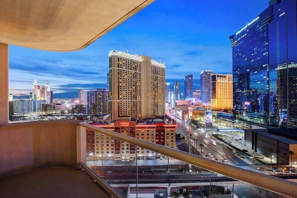 A cityscape view from a high-rise building with a prominent hotel and casino complex in the foreground. - Signature Strip View Suite (Las Vegas)