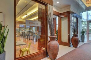 A modern interior with a reception area, large vases, and a sign reading "delights". - Signature Strip View Suite (Las Vegas)