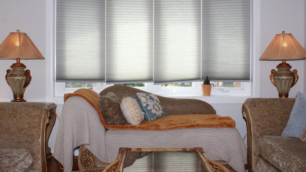 A room with a large window, a sofa, two lamps, and a small table. - Inviting Lanham Suite - Quiet and Close to DC! (Lanham)