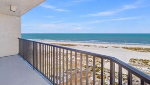 A balcony with a view of a beach and ocean. - Waterfront Resort Gulf View | Pool & Beach Access (Clearwater)